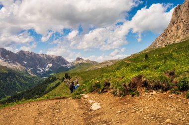 Hikers in mountains, beautiful scenic landscape of Alps, Passo San Pellegrino, North Italy
