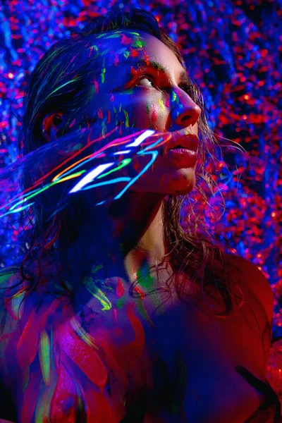 stock image girl in neon light with glowing paints