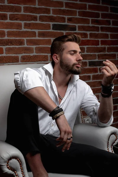 stock image A stylish Arab guy is having a business meeting while sitting in