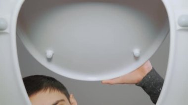 Tuvalet kapağını açıp tıkanıklığı nasıl temizleyeceğini düşünmesine şaşırdım. Gençler tuvalette kötü koku ve pis banyo hissediyorlar. Tuvaletin dibinden bak. Temizlik ve hijyen kavramı
