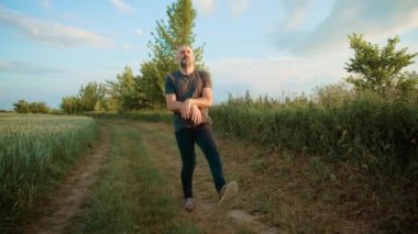 Kel adam enerjik bir şekilde dans ediyor, ikonik dansçı hareketlerini taklit ediyor. Adam tutkulu bir şekilde etkileyici bir koreografi sergiliyor, ünlü bir tarz sergiliyor. Erkek sanatçı imzalı dans hareketlerini taklit ediyor.