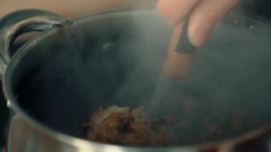 Buharda erişte ve deniz mahsulü haşlama. Midye, karides ve mürekkep balığını pişirilmiş makarnayla karıştırıyorum. Deniz kabuklularını çorbayla karıştırmak daha da lezzetlidir. Yumuşak doku ve tutarlılık için sıcak malzemeler kışkırtılıyor