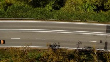 Yolcu vagonu asfalt yolda gidiyor. Minibüs kaldırımlı otoyol boyunca ilerliyor. Sedan pürüzsüz asfalt yolda ilerliyor