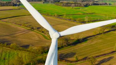 Yel değirmeni rüzgâr tarlası. Dönen büyük yel değirmeni türbinleri yenilenebilir enerji üretiyor. Rüzgar türbini yeşil elektrik üretimini desteklemek için dev bıçaklar kullanıyor. Rüzgâr bıçaklarını çalıştırarak rüzgar çiftliğinde düşük karbon enerjisi üretiyorlar.
