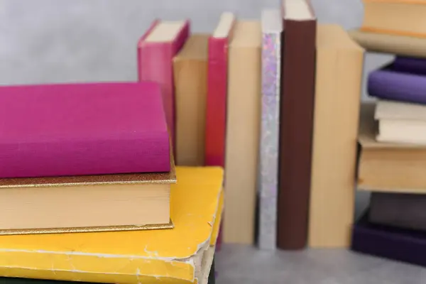 stock image stack of books on a wooden table.