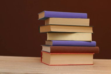 Tahta masadaki kitap yığını.