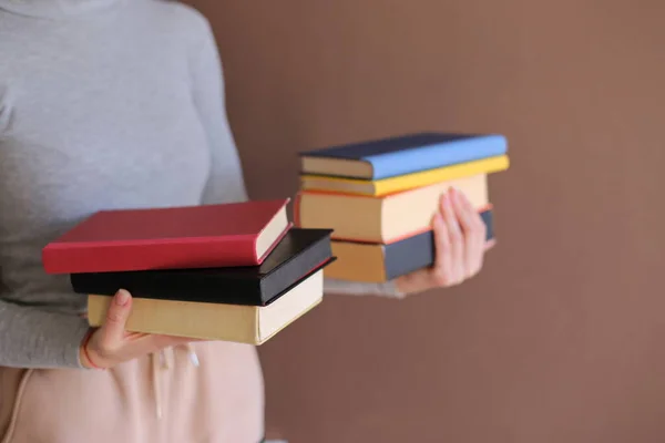 woman reading book on a stack of books