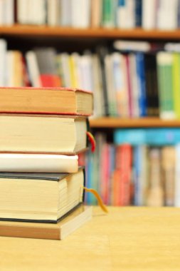 stack of books and letters of different colors on a white wooden surface.