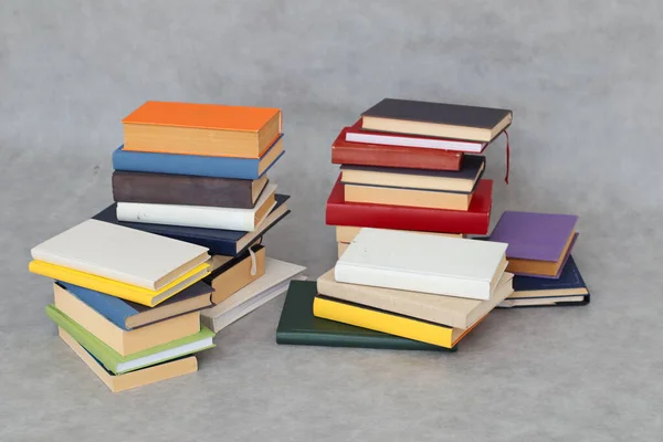 stack of books and book with letters on grey background