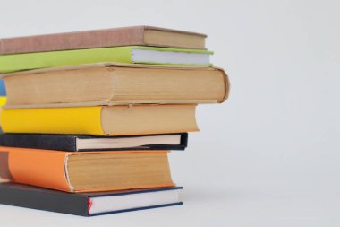 Beyaz bir arka plan üzerinde izole kitap yığını.