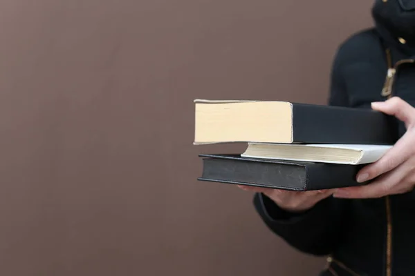 woman holding book and reading books on black background