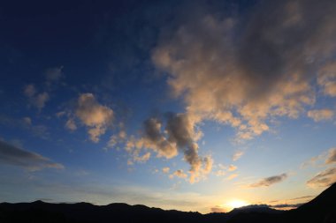 Gün batımında beyaz bulutlu mavi gökyüzü