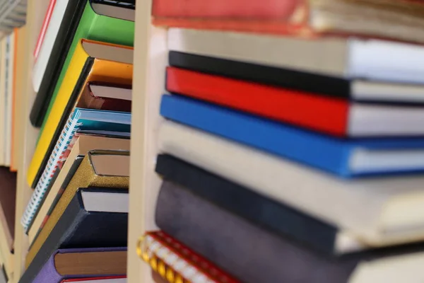 stock image stacks of many colored books in bookstore. close up.