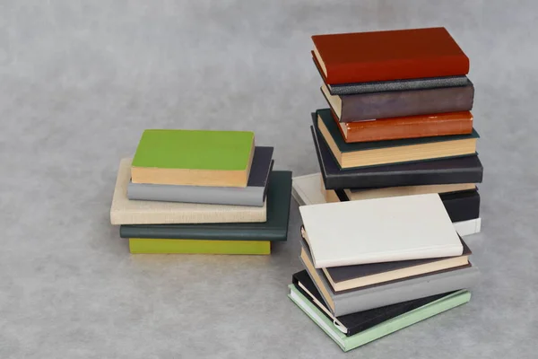stack of books and notebooks on white background