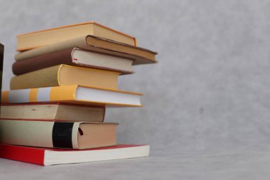 Masada kitap ve kitap yığını var, yakın plan.