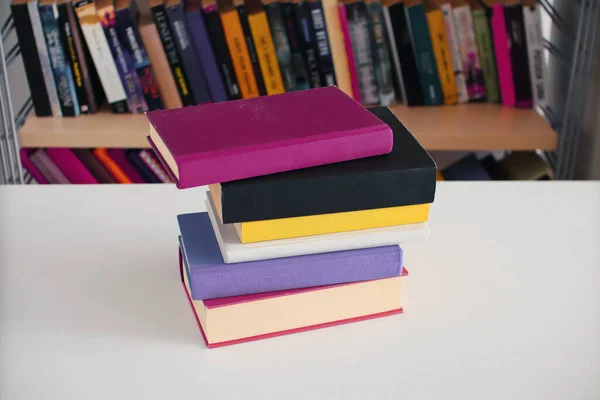stack of books with letters