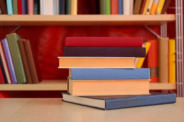 pile of books with stack of book on bookshelf background. education and learning concept.