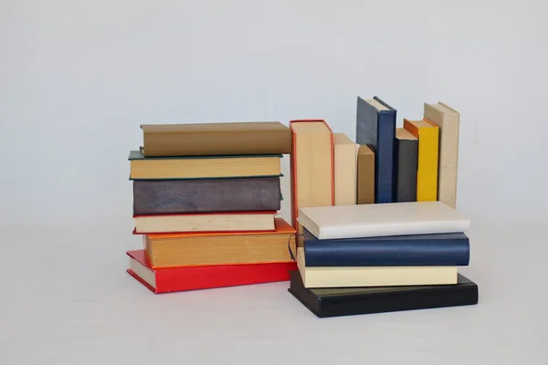 stack of books on light background.