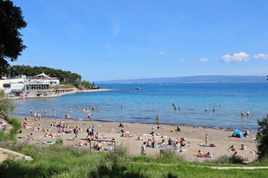 Bölünme, Hırvatistan, 26.07.2023. Turistler Split 'teki Bavice plajında dinleniyor