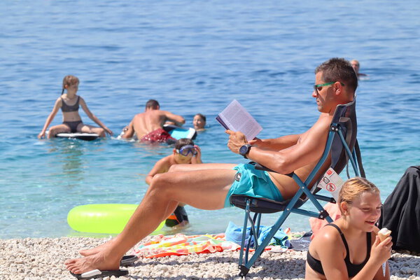 Makarska, Croatia, 06.09.2023. Tourists enjoy their vacation in the south of Croatia, on the beach by the sea