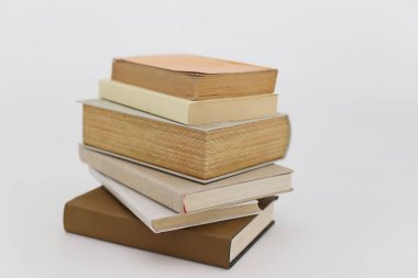 Beyaz arkaplanda bir yığın kitap.