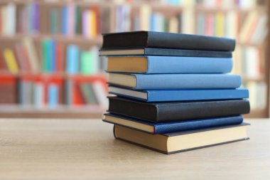 Kütüphanedeki masanın üzerinde kitap yığını