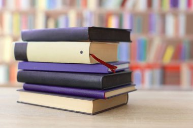 Ahşap zemin üzerinde kitap ve gözlük yığını