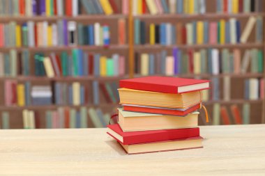 Tahta masadaki kitap yığını.