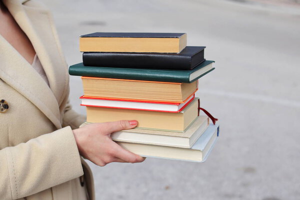 woman with red leather bag and books,Young beautiful girl holding books in her hand, set of books of the world's best writers, illustration for literature, science, science, learning, studying, history, education, art