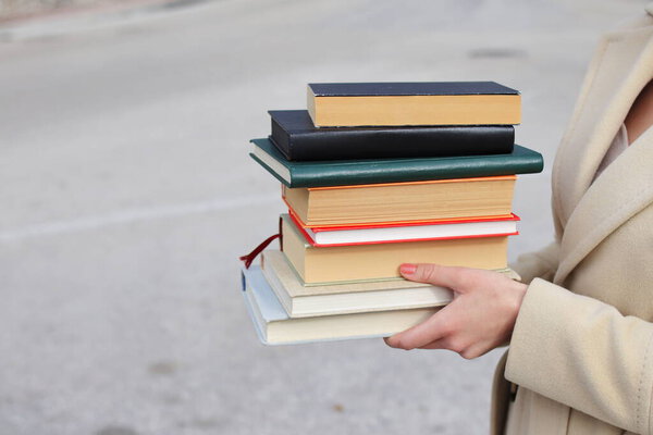 woman with red leather bag and books,Young beautiful girl holding books in her hand, set of books of the world's best writers, illustration for literature, science, science, learning, studying, history, education, art