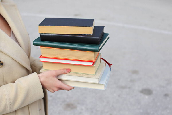 woman with red leather bag and books,Young beautiful girl holding books in her hand, set of books of the world's best writers, illustration for literature, science, science, learning, studying, history, education, art
