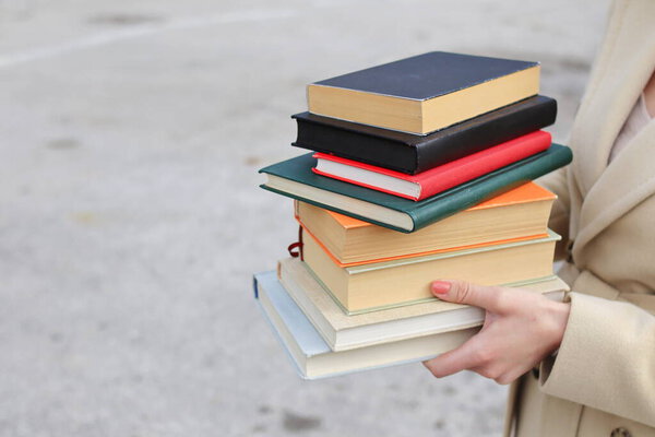woman with red leather bag and books,Young beautiful girl holding books in her hand, set of books of the world's best writers, illustration for literature, science, science, learning, studying, history, education, art