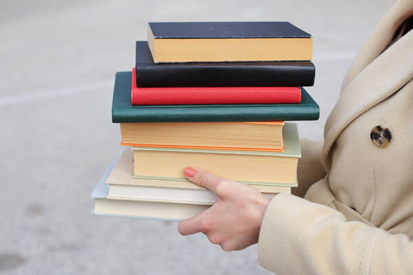 woman with red leather bag and books,Young beautiful girl holding books in her hand, set of books of the world's best writers, illustration for literature, science, science, learning, studying, history, education, art