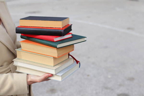 woman with red leather bag and books,Young beautiful girl holding books in her hand, set of books of the world's best writers, illustration for literature, science, science, learning, studying, history, education, art