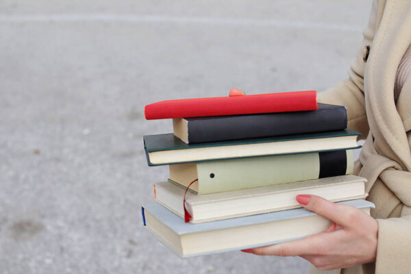 woman with red leather bag and books,Young beautiful girl holding books in her hand, set of books of the world's best writers, illustration for literature, science, science, learning, studying, history, education, art