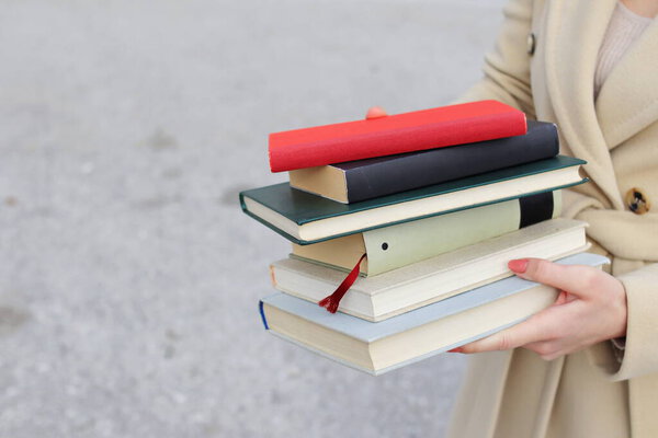 woman with red leather bag and books,Young beautiful girl holding books in her hand, set of books of the world's best writers, illustration for literature, science, science, learning, studying, history, education, art