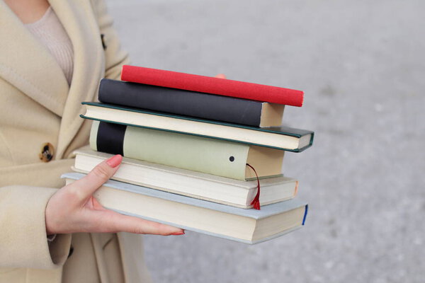 woman with red leather bag and books,Young beautiful girl holding books in her hand, set of books of the world's best writers, illustration for literature, science, science, learning, studying, history, education, art