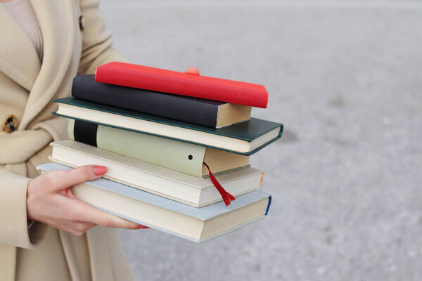 woman with red leather bag and books,Young beautiful girl holding books in her hand, set of books of the world's best writers, illustration for literature, science, science, learning, studying, history, education, art