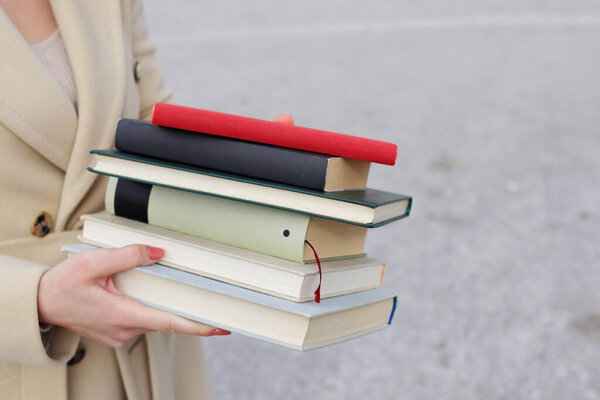 woman with red leather bag and books,Young beautiful girl holding books in her hand, set of books of the world's best writers, illustration for literature, science, science, learning, studying, history, education, art