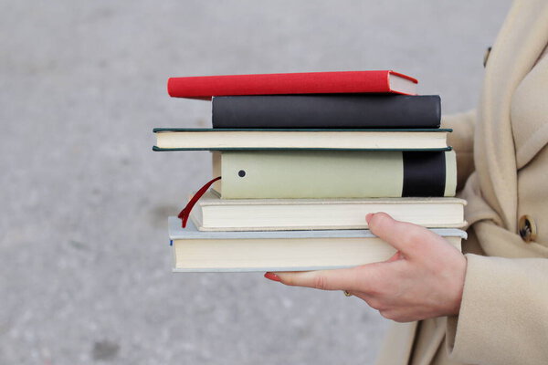 woman with red leather bag and books,Young beautiful girl holding books in her hand, set of books of the world's best writers, illustration for literature, science, science, learning, studying, history, education, art