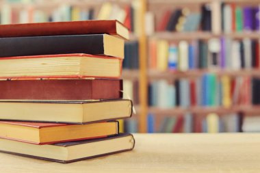 Kahve fincanı ve kitap yığını masanın üstünde.