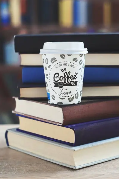 cup with tasty coffee and book on table in library. closeup, books, education,