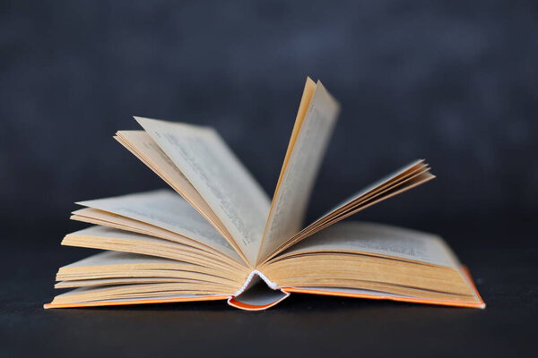 Open book on a black background,open book with a pages of a book on a dark background, education