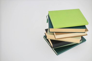 Gri arkaplanda bir yığın kitap.