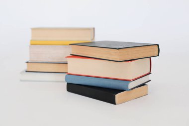 Beyaz masa, kitap yığını, kitap, yapay zeka, beyaz zemin üzerine kitaplar, beyaz zemin üzerine ünlü yazarların güzel kitapları, öğrenme, bilgi, okuma, öğrenim, İngilizce dili, İspanyolca dil, Çince