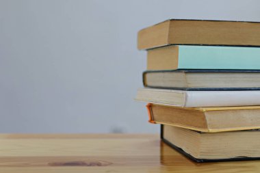 Açık arka plana karşı masadaki kitap yığını