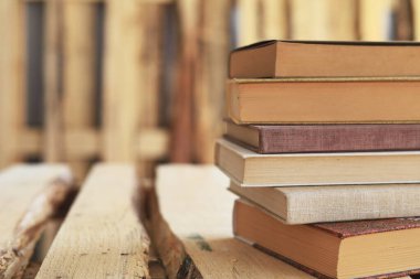 Ahşap zemin üzerine kitap yığını
