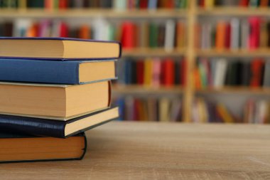 Kütüphanedeki masanın üzerinde kitap yığını