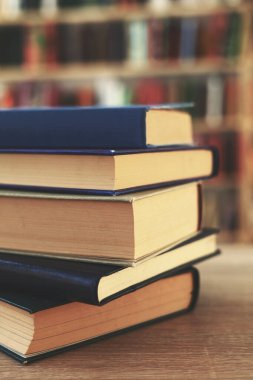 Tahta masadaki kitap yığını, Al.