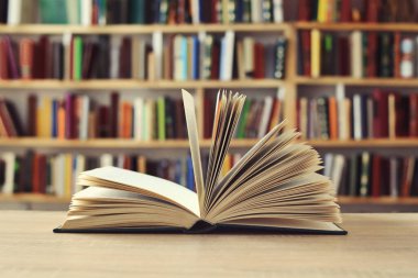 Ahşap masada renkli kitapların yığını, metin için boşluk, açık sayfalı kitap, okulda rafta duran kitaplar, ahşap masanın üzerinde açık kitap. Okul konseptine geri dönüş, yüksek kaliteli kitap fotoğrafçılığı, en iyi kitap fotoğrafı, en ünlü İskandinav yazar.